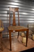 A Victorian dining chair having elaborate rose design veneer to back