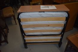 A modern fold out guest bed, very clean, looks unused