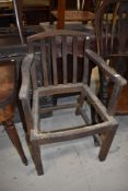 A traditional stained frame carver chair in need of recaning