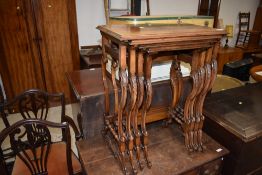 An early 20th Century walnut quartetto nest of tables on scroll frames
