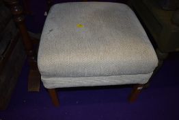 A fabric topped foot stool