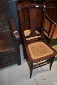 A pair of traditional stained frame cane seated bedroom chairs