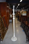 A vintage white painted standard lamp