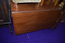 A drop leaf mahogany dining table