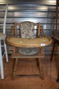 A vintage childrens low high chair with potty seat