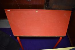 A red laminate topped childrens craft or work table standing aprox 60cm