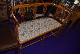 A salon settee in a satin wood having banding detailing on turned frame