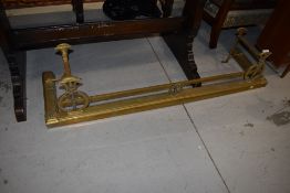 An Art Nouveau brass fender, width approx. 134cm