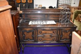 A vintage dark stained oak sideboard with rack