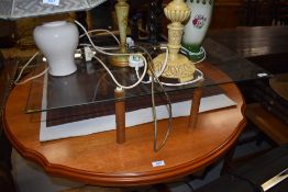 An interesting vintage glass topped coffee table on four wooden legs of cylindrical form, approx. 76