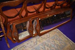 A set of four mahogany framed full length dress mirrors having carved floral decoration