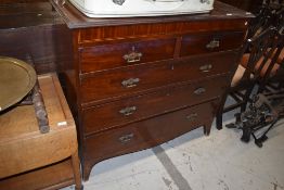 A late Victorian mahogany chest of two over three drawers, having Aesthetic movement style
