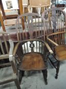 A traditional oak windsor rocking armchair