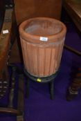 A terracotta planter and metal work stand