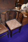 An early 20th Century stained frame corner elbow chair
