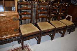 A set of four vintage stained frame ladder back chairs
