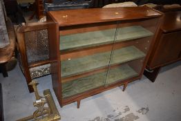 A vintage sapele bookcase, on dansette style legs, width approx. 92cm