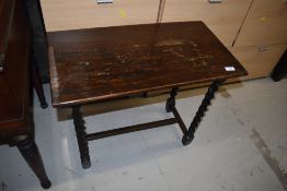 An early 20th Century oak occasional table having barley twist frame