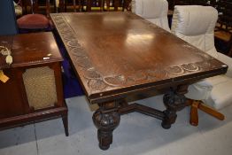 An early 20th Century oak drawer leaf table, by Waring and Gillow, having lunette carved