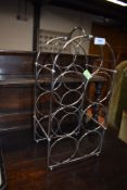 A stainless steel wire work wine rack