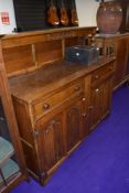 An early 20th Century oak sideboard, having ledge back and linen fold doors, width approx. 139cm