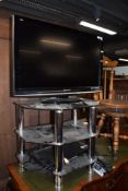 An entertainment system with Panasonic television glass and chrome stand and dvd player