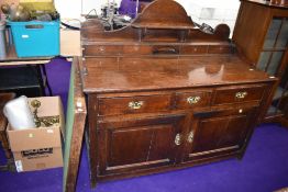 A period oak dresser base, having ledge back with four drawers, three frieze drawers and double