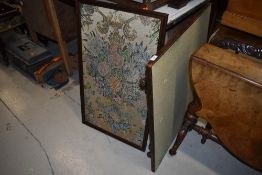 A traditional folding card table, oak frame and a framed embroidery