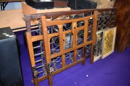 An Arts and Crafts style golden oak frame single bed, with metal base