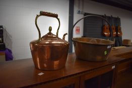 A traditional copper kettle and brass jam pan
