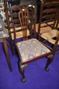 A mahogany dining chair with ball and claw feet
