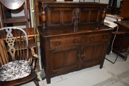 A dark stained Ercol style court cupboard, width approx. 126cm