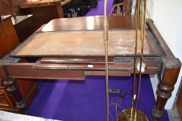 An antique extending dining table in mahogany