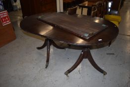 A Regency style extending dining table, nice quality on brass claw feet and casters, 1 additional