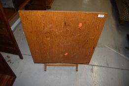 A vintage golden oak folding table