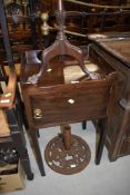 A 19th Century mahogany pot cupboard having gallery top on square legs