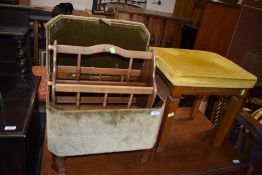 A upholstered foot stool in green satin with magazine rack