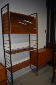 A vintage metal frame ladderax shelf unit with glazed display and three drawer sections