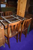A mid 20th Century draw lead table and four chairs