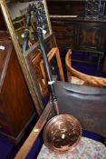 A wooden and copper bodied bed warming pan