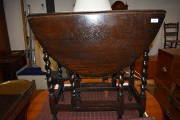 A traditional dark oak twist gateleg table, width approx. 70cm
