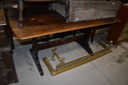 A traditional dark stained Ercol style refectory style table