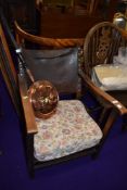 An Edwardian smokers style chair with leather back and oak frame