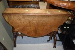 A Victorian walnut sutherland table having shaped top , turned frame , shaped legs, on pot