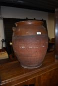A large terracotta two handled pot, no lid