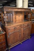 An oak court cupboard with traditional carvings width approx 120cm