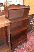 A mahogany shelf with drawer set