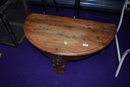 An Indonesian hardwood half moon coffee table, with storage