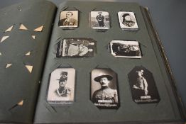 An album of Ogdens Guinea Gold Cigarette Cards Real Photo's, mainly of Military interest,