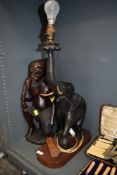 A table lamp hand carved as an African elephant standing at 60cm